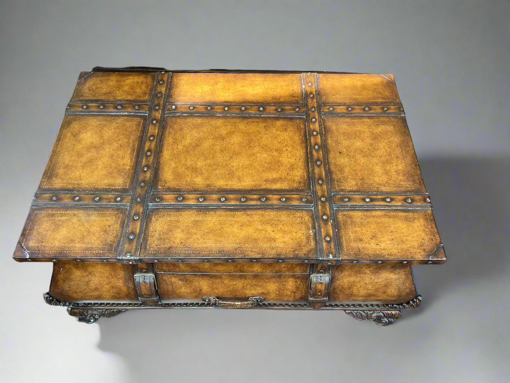 top view of coffee table, rubbed burnished brown patina finish with rivets, leather and gold details.