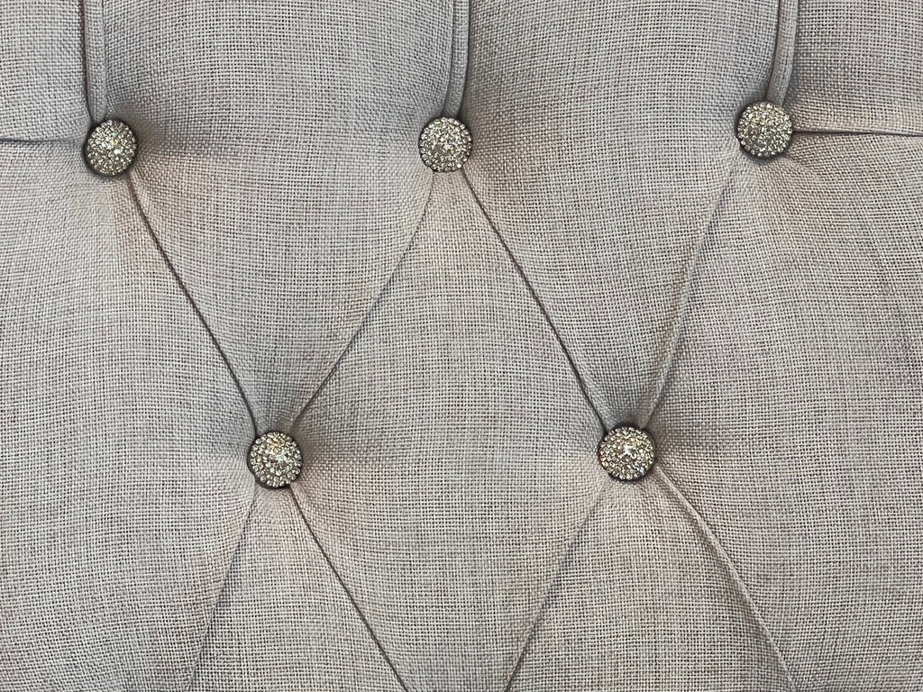 Elegant wing-backed slipper chair with sparkly buttons