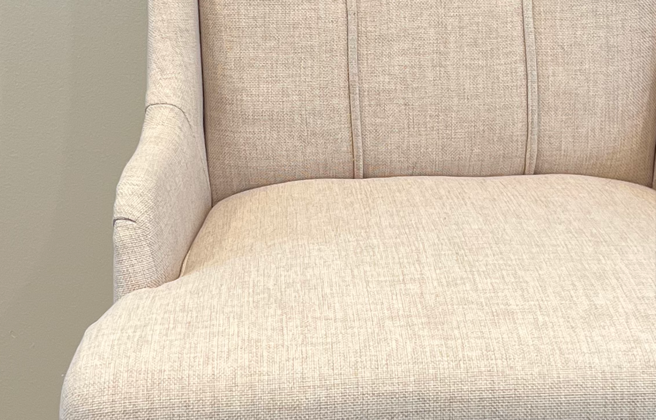 Elegant wing-backed slipper chair with sparkly buttons